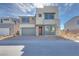 Modern two-story home with a neutral color palette, stone accents, and a two-car garage at 1321 Crimson Sunbird Ave, North Las Vegas, NV 89084