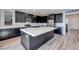 Gourmet kitchen features a large island, dark cabinets, stainless steel appliances, and bright countertops at 1321 Crimson Sunbird Ave, North Las Vegas, NV 89084
