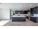 Open kitchen featuring a large center island, stainless steel appliances, and sleek, dark cabinetry at 1321 Crimson Sunbird Ave, North Las Vegas, NV 89084