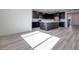 Open-concept space with vinyl flooring, white walls and kitchen featuring a large island at 1321 Crimson Sunbird Ave, North Las Vegas, NV 89084
