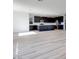 Open-concept floor plan with luxury vinyl flooring, leading to a modern kitchen with a large island at 1321 Crimson Sunbird Ave, North Las Vegas, NV 89084