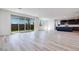 Spacious living area featuring sliding glass doors to backyard and dark cabinetry in kitchen at 1321 Crimson Sunbird Ave, North Las Vegas, NV 89084