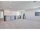 Bright loft area featuring neutral carpet, black metal railing, recessed lighting and natural sunlight at 1321 Crimson Sunbird Ave, North Las Vegas, NV 89084