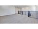 Bright loft area featuring neutral carpet, black metal railing, and minimalist design, perfect for flexible living at 1321 Crimson Sunbird Ave, North Las Vegas, NV 89084