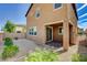 Backyard with a mix of desert rock, green plants and a small covered patio area at 139 Fulgora St, Henderson, NV 89074