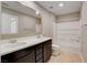 Neutral bathroom features a double sink vanity with dark wood cabinets and a shower-tub combo at 139 Fulgora St, Henderson, NV 89074