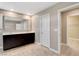 Well-lit bathroom showcasing double sinks, dark wood cabinets, and modern mirror at 139 Fulgora St, Henderson, NV 89074