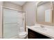 Bathroom with sliding glass shower doors, toilet, mirror and sink at 139 Fulgora St, Henderson, NV 89074