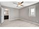 Well-lit bedroom features a bathroom ensuite, window, ceiling fan, and light wood-look flooring at 139 Fulgora St, Henderson, NV 89074