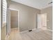 A bright bedroom with light hardwood floors and open doors to closet and hallway at 139 Fulgora St, Henderson, NV 89074