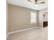 Bright bedroom features a ceiling fan, plantation shutters, and light wood-look flooring at 139 Fulgora St, Henderson, NV 89074