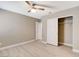 Bright bedroom features a ceiling fan, closet and light wood-look flooring throughout at 139 Fulgora St, Henderson, NV 89074