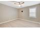 Neutral bedroom features a ceiling fan, plantation shutters, and light wood-look flooring at 139 Fulgora St, Henderson, NV 89074