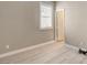 A bright bedroom with light hardwood floors and white door with white trim at 139 Fulgora St, Henderson, NV 89074