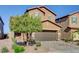 Inviting two-story home featuring a brick driveway, two-car garage and well-maintained landscaping at 139 Fulgora St, Henderson, NV 89074