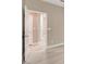 Hallway view with open door, showing neutral wall colors and tile flooring at 139 Fulgora St, Henderson, NV 89074