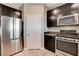 Modern kitchen featuring stainless steel appliances and dark wood cabinetry at 139 Fulgora St, Henderson, NV 89074