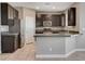 Kitchen with dark cabinets, stainless steel appliances and peninsula with gray countertops at 139 Fulgora St, Henderson, NV 89074