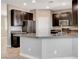 Kitchen with dark cabinets, stainless steel appliances, peninsula and gray countertops at 139 Fulgora St, Henderson, NV 89074