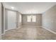Bright and spacious living room showcasing neutral colors, tile flooring, and a contemporary light fixture at 139 Fulgora St, Henderson, NV 89074