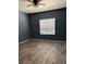 Bedroom with wood-look floors, a ceiling fan, and a window at 1838 N Jones Blvd, Las Vegas, NV 89108