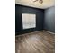 Bedroom with wood-look floors, a ceiling fan, and a window at 1838 N Jones Blvd, Las Vegas, NV 89108