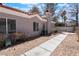 The exterior of the home featuring large windows, greenery, and a sidewalk at 1838 N Jones Blvd, Las Vegas, NV 89108