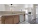 Open kitchen featuring wood cabinets, white appliances, and a view into the living room at 1838 N Jones Blvd, Las Vegas, NV 89108