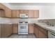 Well-lit kitchen with white appliances, ample counter space, and wood cabinets at 1838 N Jones Blvd, Las Vegas, NV 89108