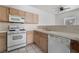 Bright kitchen with white appliances, wood cabinets, and tile countertops at 1838 N Jones Blvd, Las Vegas, NV 89108