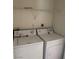 A laundry room with a washer and dryer and a shelf at 1838 N Jones Blvd, Las Vegas, NV 89108