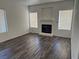 Spacious living room features a fireplace and contemporary wood-look flooring under natural light at 1838 N Jones Blvd, Las Vegas, NV 89108
