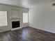 Bright living room with a fireplace, neutral walls, modern flooring and natural light from large windows at 1838 N Jones Blvd, Las Vegas, NV 89108