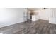 Open-concept living area with sleek floors flowing into a cozy kitchen space at 1838 N Jones Blvd, Las Vegas, NV 89108