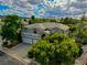 Aerial view of a charming home with lush trees and landscaping, and a three-car garage at 1925 Grey Eagle St, Henderson, NV 89074