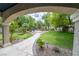 Lush backyard featuring a stone path, fire pit with seating area, mature trees, and manicured landscaping at 1925 Grey Eagle St, Henderson, NV 89074