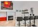 Modern bar area with a marble countertop, seating for four, and stylish decor adjacent to a fireplace at 1925 Grey Eagle St, Henderson, NV 89074