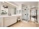 Primary bathroom with dual sinks, vanity, and glass enclosed shower at 1925 Grey Eagle St, Henderson, NV 89074
