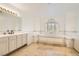 Bright bathroom features a large soaking tub with tiled surround, and a spacious vanity with double sinks at 1925 Grey Eagle St, Henderson, NV 89074