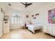 Cozy bedroom with white furniture, decorative wall art, and a plush rug creating a comfortable retreat at 1925 Grey Eagle St, Henderson, NV 89074