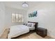 Well-lit bedroom features neutral walls, a comfortable bed with decorative pillows, and a modern aesthetic at 1925 Grey Eagle St, Henderson, NV 89074