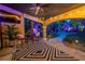 Comfortable covered patio features string lights, ceiling fan and backyard views with walkway at 1925 Grey Eagle St, Henderson, NV 89074