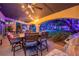 A shaded patio with outdoor dining space, string lights, ceiling fans and backyard views at 1925 Grey Eagle St, Henderson, NV 89074