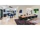 Open concept dining room with modern table and chairs adjacent to a gourmet kitchen; great layout for entertaining at 1925 Grey Eagle St, Henderson, NV 89074