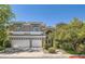 Charming two-story home with a three-car garage, mature trees and arched windows at 1925 Grey Eagle St, Henderson, NV 89074