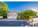 Traditional style home with three car garage, desert landscaping, and lush mature trees at 1925 Grey Eagle St, Henderson, NV 89074