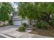 Charming two-story home featuring a three-car garage and mature tree in a lush landscaped yard at 1925 Grey Eagle St, Henderson, NV 89074