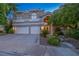 Charming two-story home features a well-manicured front yard, a three car garage, and an inviting entryway at 1925 Grey Eagle St, Henderson, NV 89074