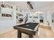 Open concept with tile floors, billiards table, staircase, and decorative light fixtures at 1925 Grey Eagle St, Henderson, NV 89074