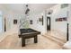 Bright game room features a rustic billiard table and ample natural light from the large arched window at 1925 Grey Eagle St, Henderson, NV 89074